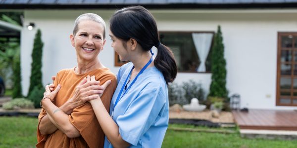 Nurse or caregiver and elderly woman support, healthcare service and health portrait at home. Medical physiotherapy, doctor helping and elderly patient with disability in home.