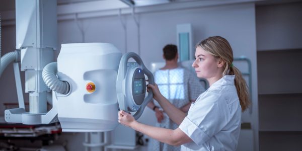 Radiologist setting up chest x-ray in hospital
